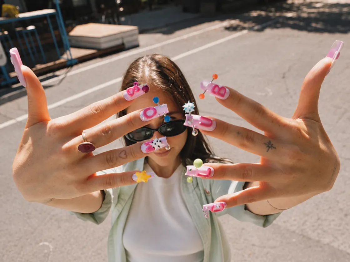 Hands showing freshly painted, decorated nails