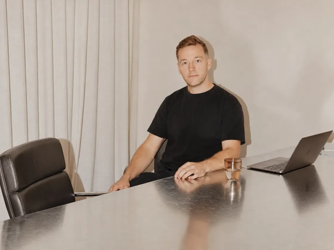 A consultant at a meeting table with a laptop