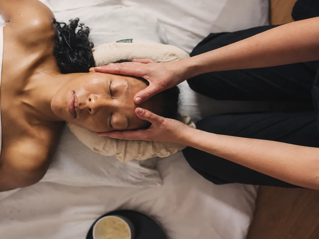 A client lying down during a face massage
