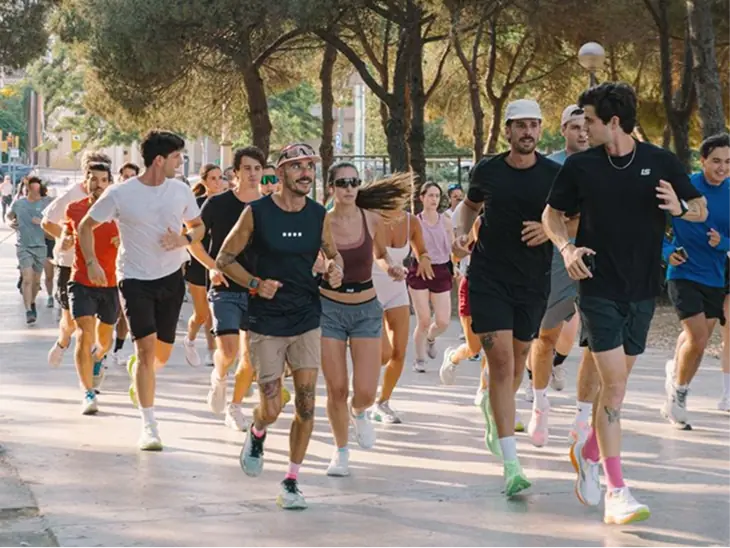 A run club jogging together down a tree-lined street
